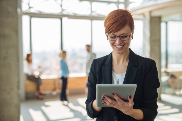 Attractive businesswoman working on a tablet in the office.